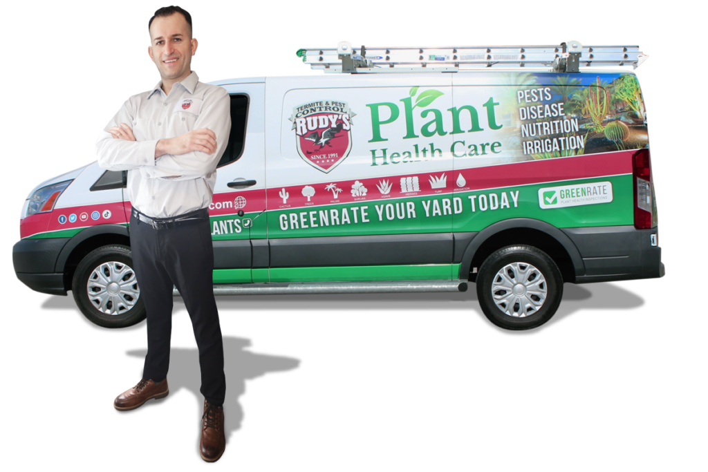 A male employee standing in front of a GreenRate Van