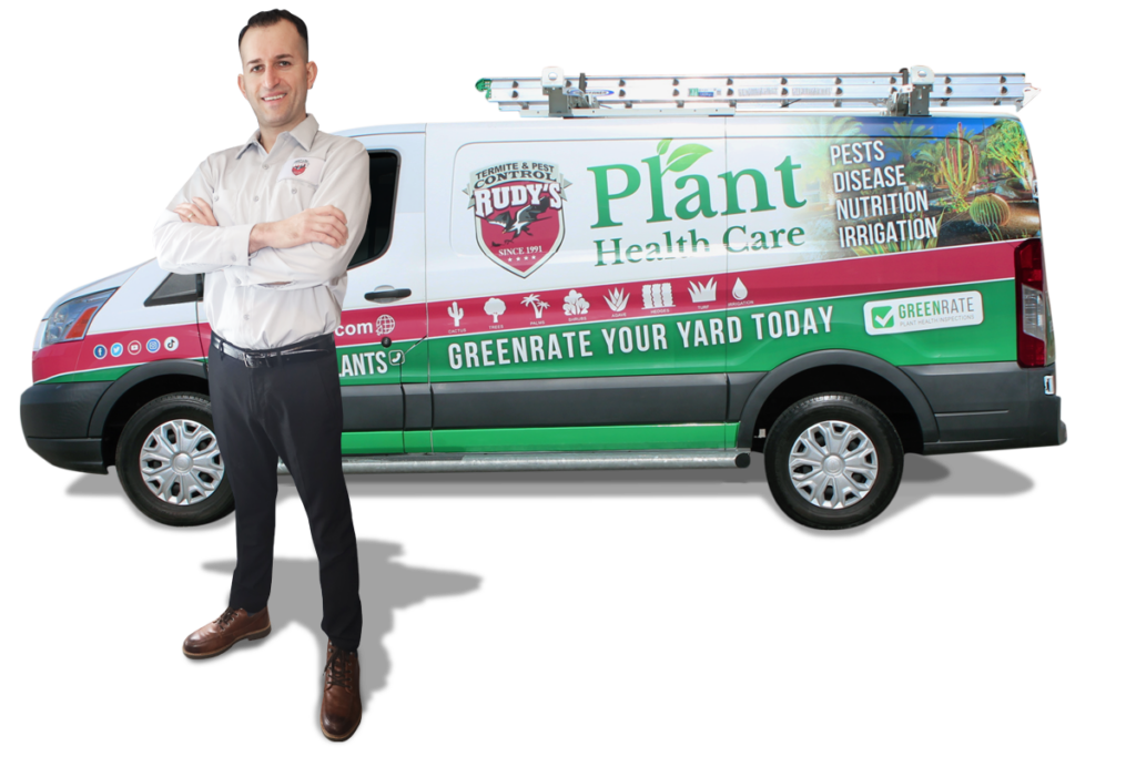 A male employee standing in front of a GreenRate Van