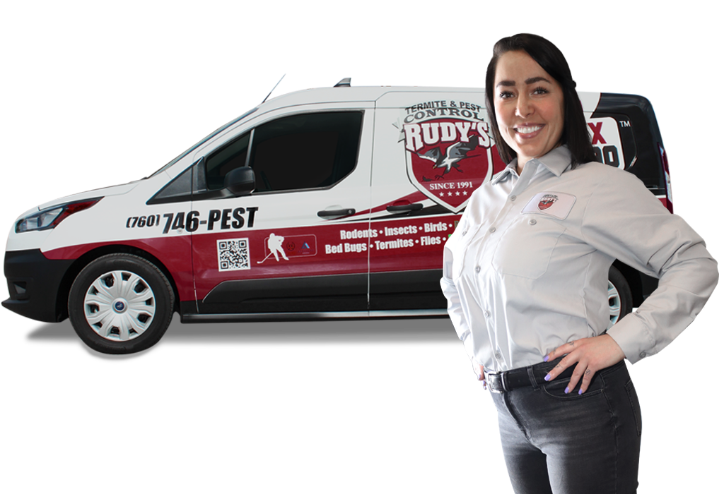 A rudy's employee standing in front of a Rudy's pest control truck