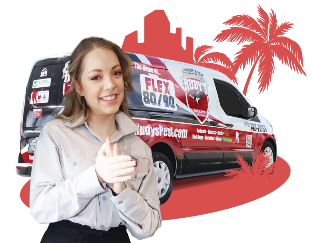 Employee smiling in front of a Rudy's Pest Control Vehicle.