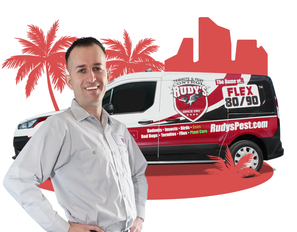 Employee smiling in front of a Rudy's Pest Control Vehicle.