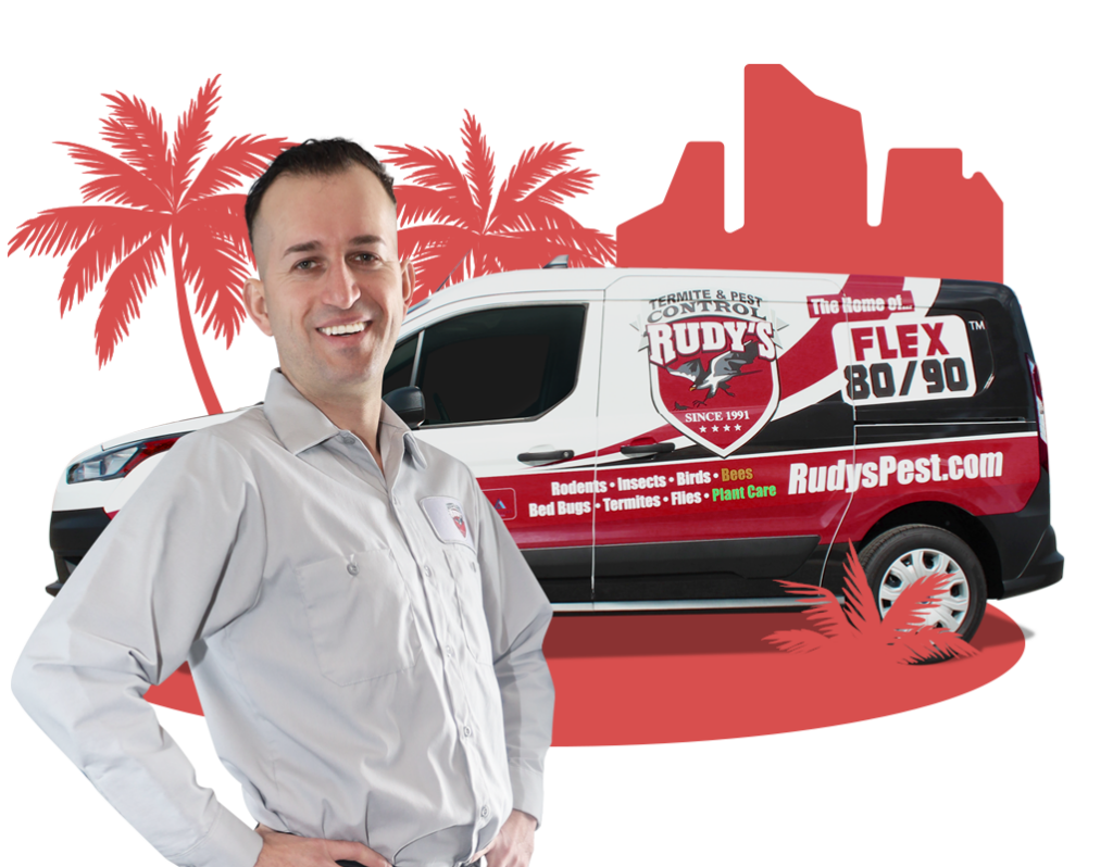 Employee smiling in front of a Rudy's Pest Control Vehicle.